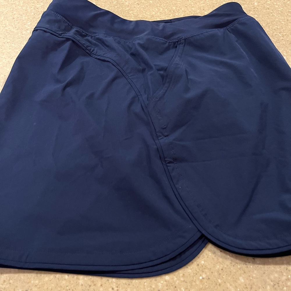 Lands End size 8 swim skort. Like new condition. Dk navy with pockets.